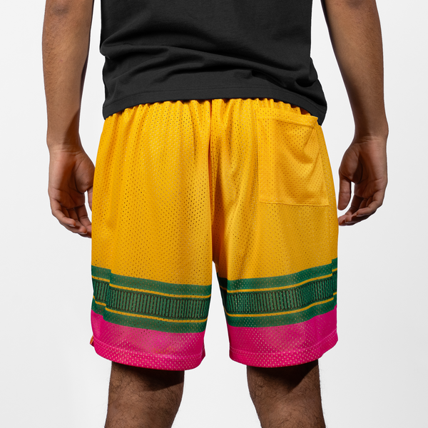 Rear view of a youth modeling a pair of Victus Youth Pencil Mesh Shorts - Yellow