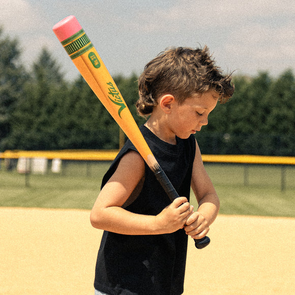 Young boy shouldering the Victus Pencil Yardstick Plastic Bat