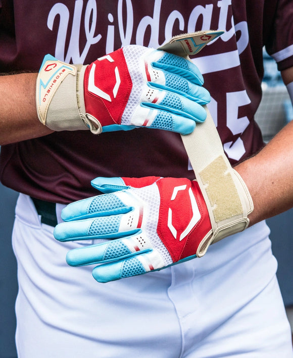 Player wearing the Evoshield Youth X-SRZ™ Carbyne Batting Glove with Strap - Red/White/Ice