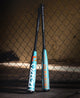 2026 DeMarini Omega -3 BBCOR Baseball Bats leaning against a fence