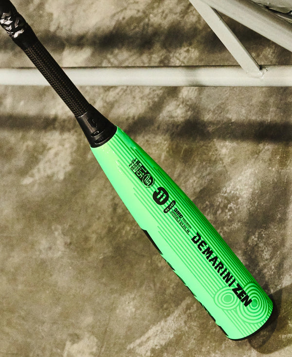 2026 DeMarini Zen -11 USSSA Baseball Bat leaning against a lattice