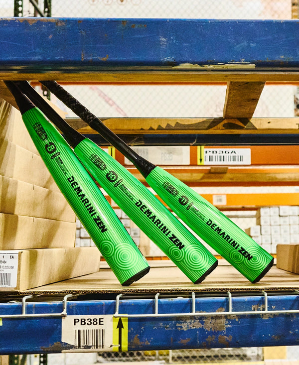 Three 2026 DeMarini Zen USSSA Baseball Bats on a shelf in a warehouse