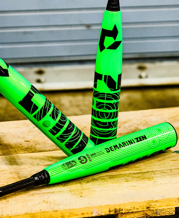Three 2026 DeMarini Zen -5 USSSA Baseball Bats on a wooden surface