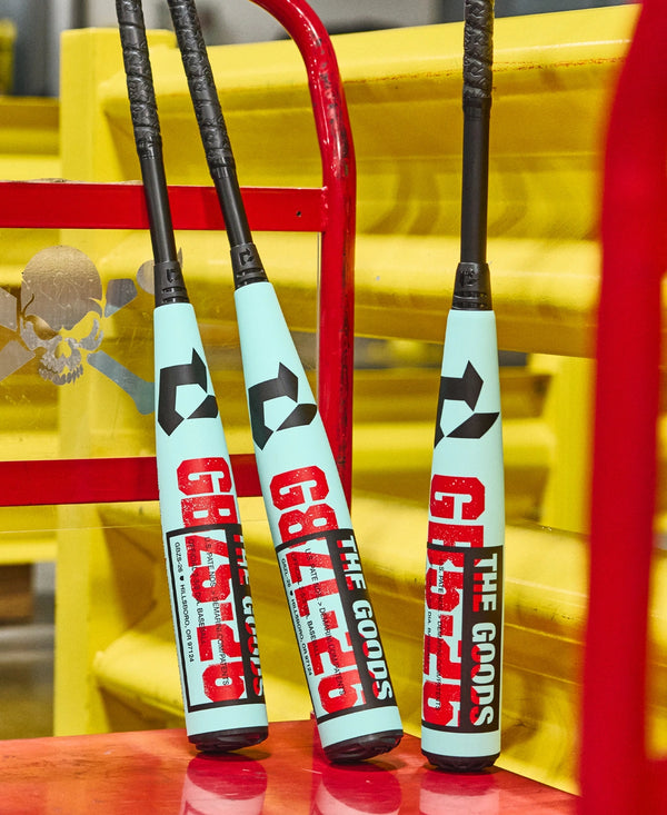 2026 DeMarini The Goods™ -10 USSSA Baseball Bats resting on a cart