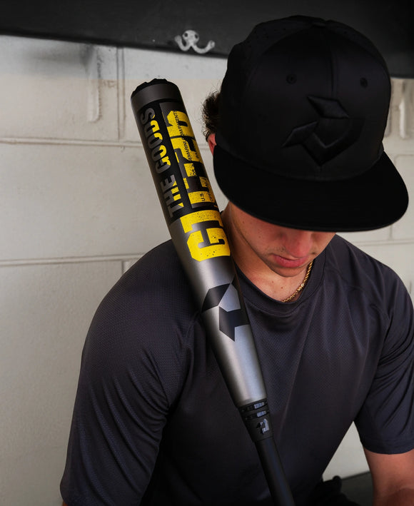 Player holding the 2026 DeMarini The Goods™ Gunmetal -3 BBCOR Baseball Bat in the dugout