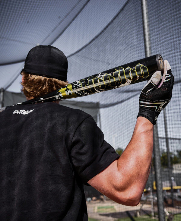 Player with the 2027 DeMarini Voodoo One -3 BBCOR Baseball Bat resting on his shoulders
