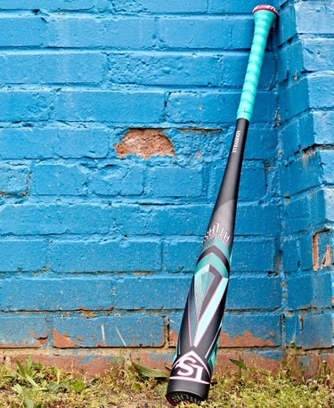 2025 Louisville Slugger Atlas™ -3 BBCOR Baseball Bat leaning against a blue brick wall