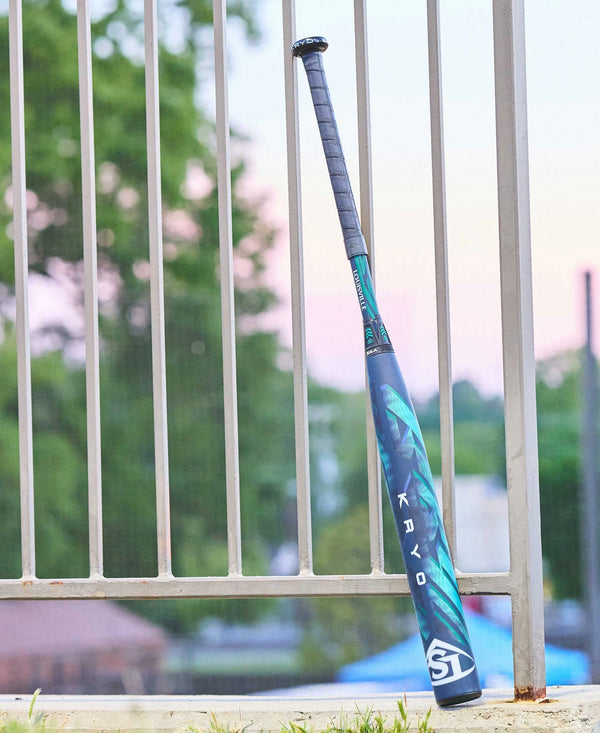 2025 Louisville Slugger KRYO -11 Fastpitch Bat leaning against a fence