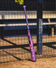 2026 Louisville Slugger KRYO Thundernight Fastpitch Bat leaning against a fence