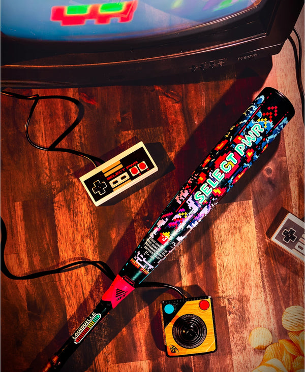 2026 Louisville Slugger Select PWR™ Player 1 -3 BBCOR Baseball Bat on a gaming table