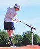 Young player batting off a tee with the 2027 Louisville Slugger Omaha® -10 USA Baseball Bat