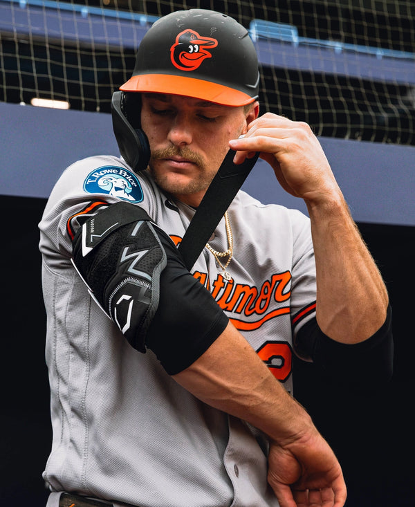 Baltimore star Gunner Henderson putting on the Evoshield Pro-SRZ™ 3.0 Double Strap Batter's Elbow Guard