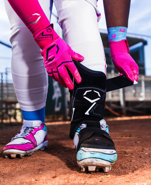 Player putting on the Evoshield Pro-SRZ™ 3.0 Batter's Leg Guard