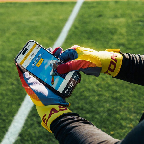 Player using cell phone while wearing the Easton Walk-Off Ethos Batting Gloves