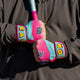 Player gripping a bat with the Easton Walk-Off Ethos Spring Break Youth Batting Gloves - Columbia/Pink