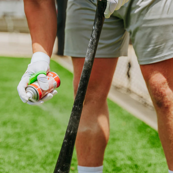 Batter applying All Star Big Fly™ Bat Tack Spray to his bat