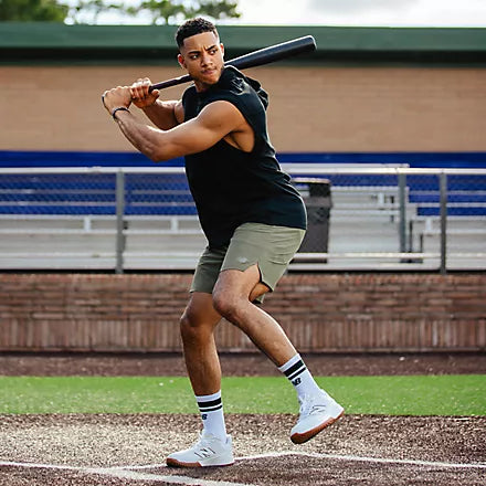 Player batting while wearing the New Balance Fresh Foam 3000 v7 Men's Turf/Trainer - White with Black