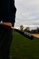 Player or coach holding a BamBooBat 21” Bamboo Training Bat