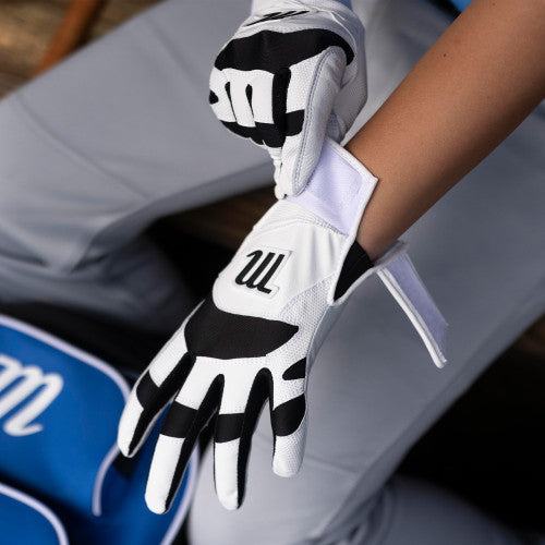 Player adjusting his Marucci Signature Youth Batting Glove - White